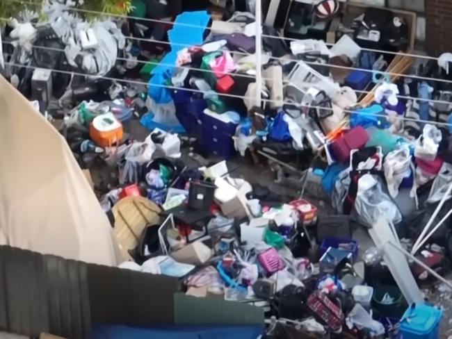 Residents in Huntfield Heights are increasingly concerned with one home that has mountains of items filling it's yard. Picture: 7NEWS