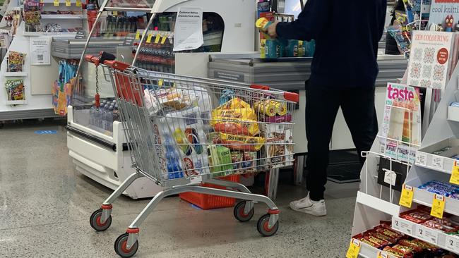 A man loads up on bottled water at The Glen after some Melbourne water sources have been contaminated after Thursday's storm. Picture: Suzan Delibasic