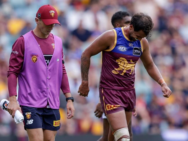 BRISBANE, AUSTRALIA - MARCH 23: Callum Ah Chee of the Lions is helped from the ground during the 2025 AFL Round 02 match between the Brisbane Lions and the West Coast Eagles at The Gabba on March 23, 2025 in Brisbane, Australia. (Photo by Russell Freeman/AFL Photos via Getty Images)