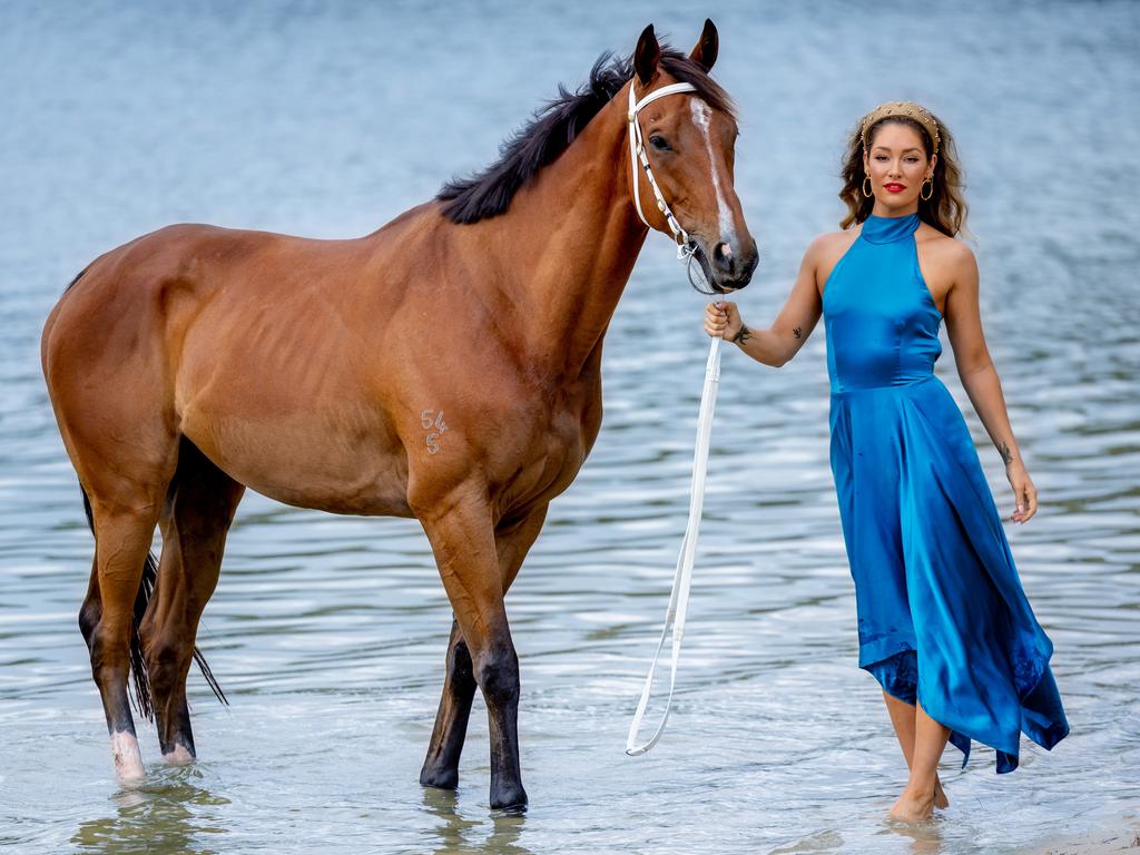 Model Erin McNaught and Dustin the retired racehorse ahead of the Magic Millions race day. Picture: Luke Marsden