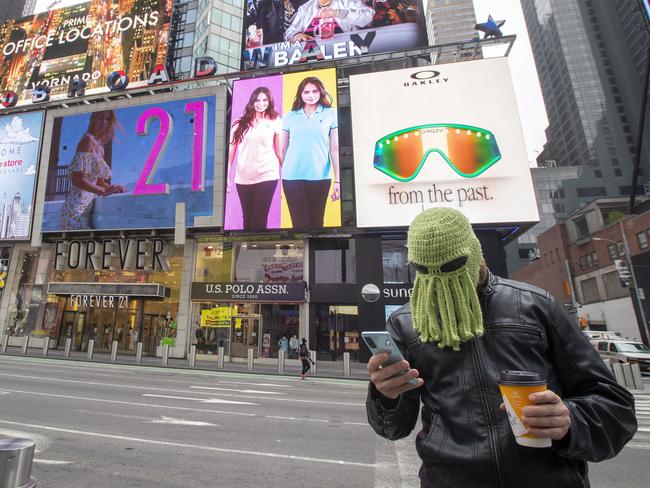 Jon Makay, of Harlem, wears an octopus hat to fend off coronavirus in New York's Times Square. Picture: AP