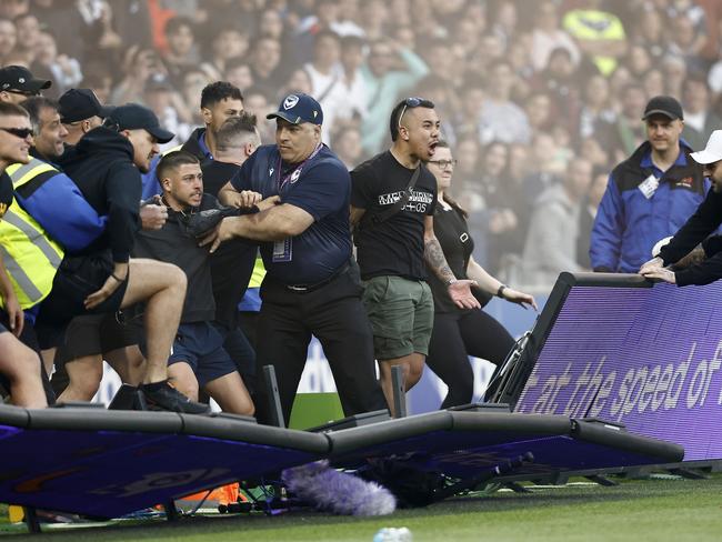 MELBOURNE, AUSTRALIA - DECEMBER 17: Fans storm the pitch in protest during the round eight A-League Men's match between Melbourne City and Melbourne Victory at AAMI Park, on December 17, 2022, in Melbourne, Australia. (Photo by Darrian Traynor/Getty Images)