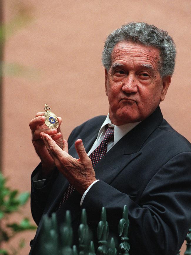 Charlie Perkins holding his Order of Australia Medal.