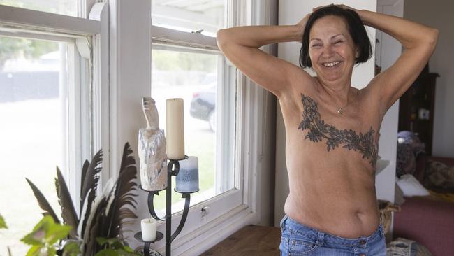 Beautiful survival tactic – Kate Brokate had a bilateral mastectomy because of breast cancer, but a tattoo of her favourite flowers and is incredibly happy with the result. Picture: Simon Cross