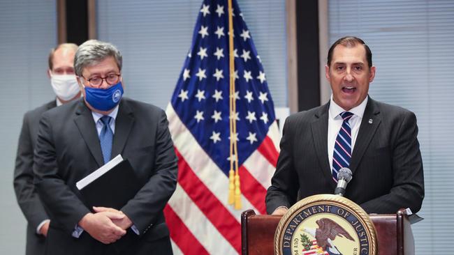 William Barr (L) listens as US Attorney John R. Lausch, Jr. of the Northern District of Illinois speaks on Operation Legend, the federal law enforcement operation, during a press conference in Chicago. Picture; AFP.