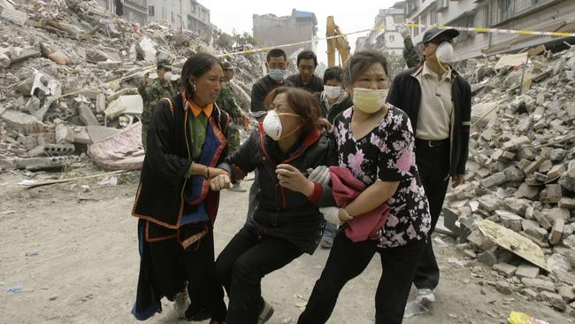 A Chinese woman is comforted as she cries after her mother's dead body was found near the rubble of a collapsed building in Dujiangyan, southwest Sichuan Province in 2008, nearly a week after an earthquake devastated the area.