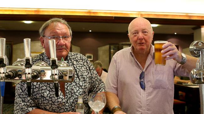 Two men celebrate being able to stand at the bar to be served in a Manchester pub. Picture: Getty Images.