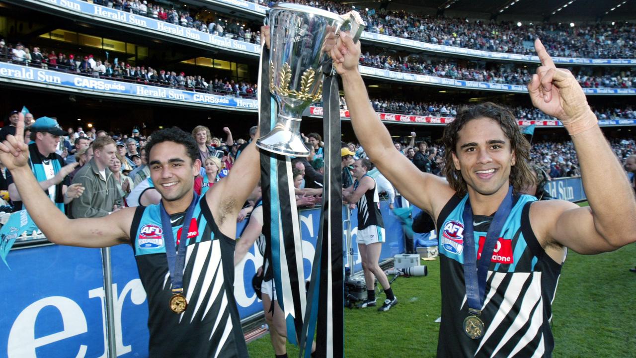 Shaun Burgoyne celebrates Port’s 2004 premiership with brother Peter.