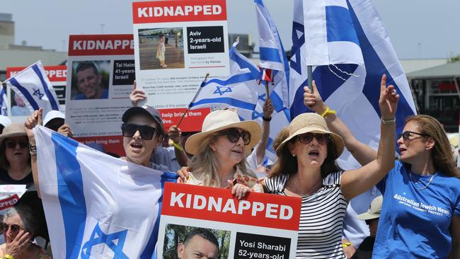 Attendees hold ‘kidnapped’ signs at the ‘Set Them Free’ vigil in Sydney on Sunday. Picture: John Feder / The Australian.