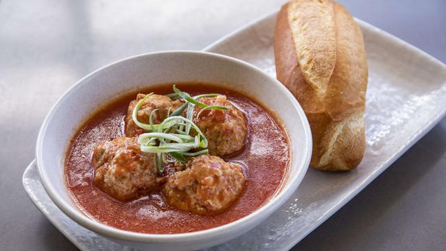 Pork meatballs come in a tomato broth with a baguette on the side. Picture: Mark Cranitch.