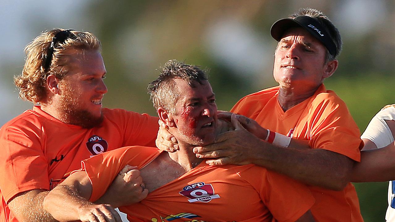 Port Douglas trainer Glenn Dickson has blood spilling from his face after an altercation with Trinity Bulldogs player Brian Durbidge during the Port Douglas and Centrals Trinity Beach Bulldogs AFL Cairns preliminary final at Cazalys. PICTURE: JUSTIN BRIERTY