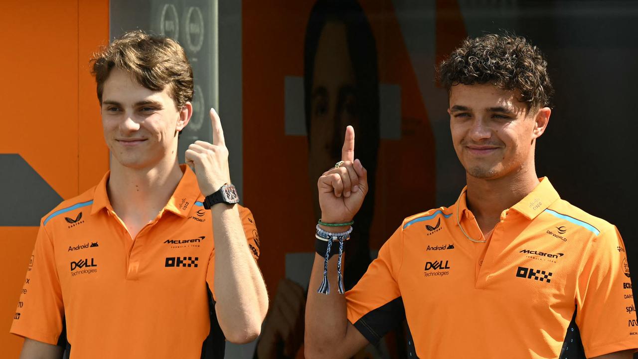 TOPSHOT - McLaren's Australian driver Oscar Piastri (L) and McLaren's British driver Lando Norris pose ahead of the Formula One Azerbaijan Grand Prix in Baku on September 12, 2024. (Photo by Natalia KOLESNIKOVA / AFP)