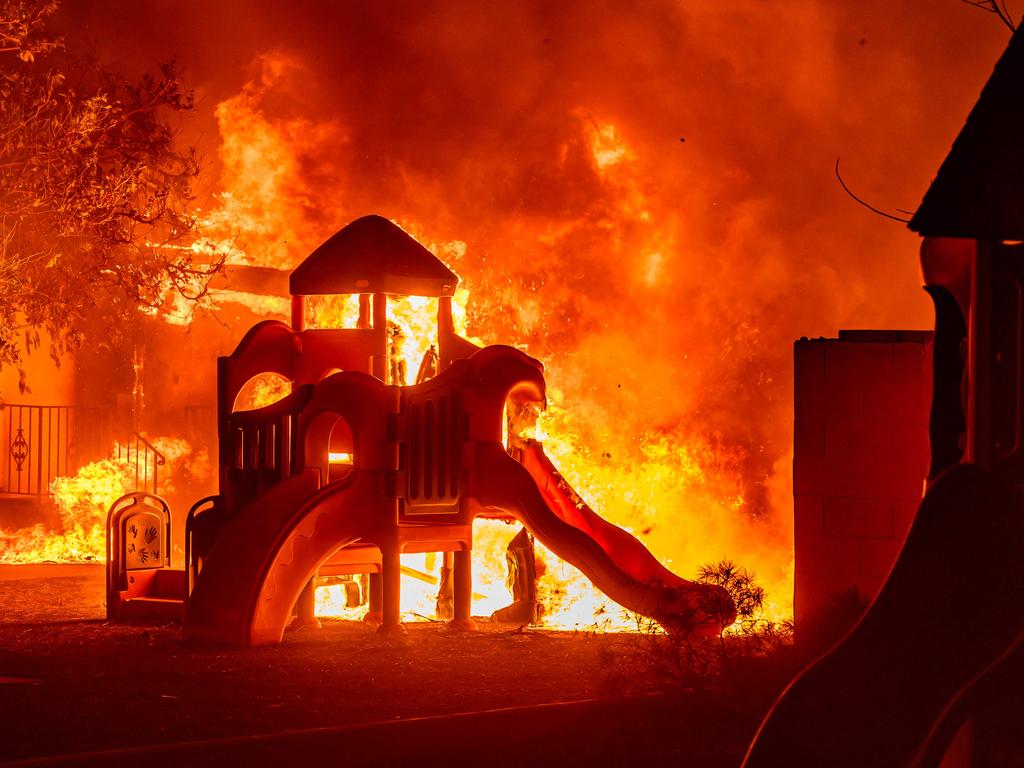 A playground in a residential neighbourhood burns. Picture: Josh Edelson/AFP