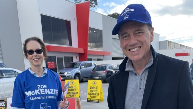 MP Greg Hunt, who is not recontesting his seat this election, with wife Paula Lindsey handing out how to vote cards in support of Zoe McKenzie at an early voting booth in Mornington on May 9. Picture: Lucy Callander