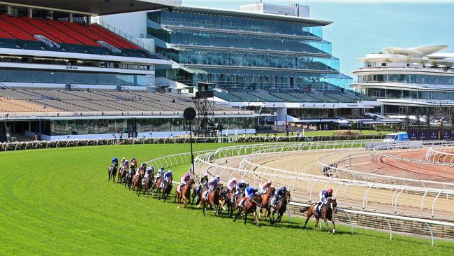 Empty stands tower over the track as Twilight Payment leads the pack on the first turn during the running of the 2020 Melbourne Cup at Fleming Racecourse. Picture: Aaron Francis