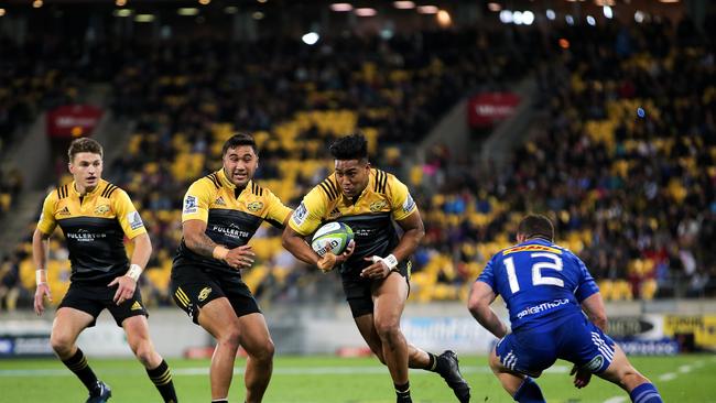 Julian Savea of the Hurricanes makes a break on his way to scoring a try.