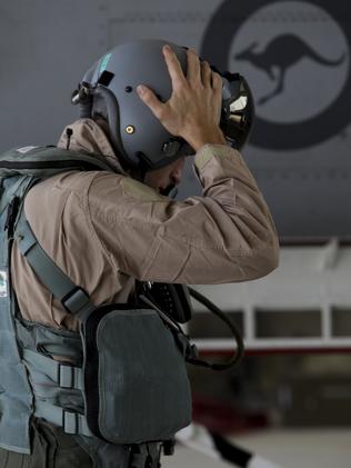 Geared up ... A RAAF F/A-18F Super Hornet Air Combat Officer fits his helmet prior to the first combat mission in Iraq. Picture: Supplied