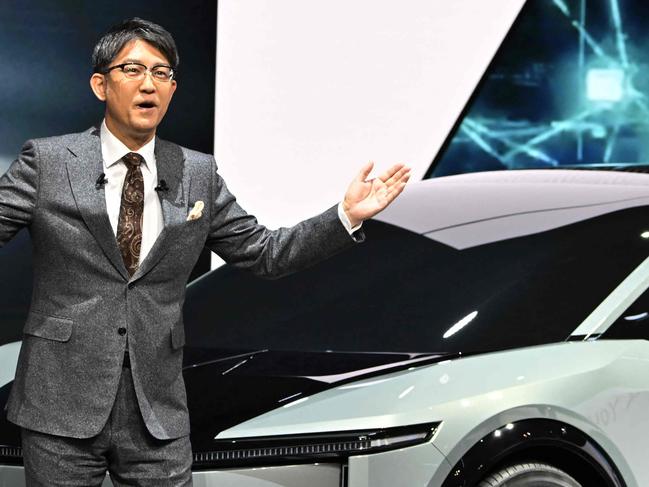 Toyota Motor President Koji Sato delivers a speech next to a FT-3e, a new electric vehicle concepts SUV, at the Japan Mobility Show 2023 in Tokyo on October 25, 2023. (Photo by AFP)