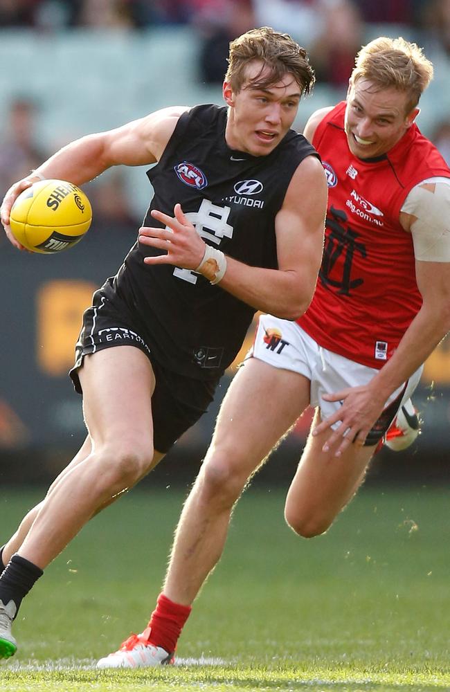 Carlton’s Patrick Cripps sprints away from Demon Bernie Vince. Picture: Michael Willson (Getty Images)