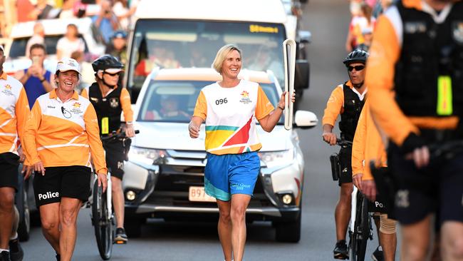 Olympian and Nova host Susie O'Neill carries the Queen's Baton during its Relay in Brisbane. Picture: AAP Image/Dan Peled