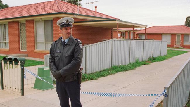 A policeman guards the murder crime scene.