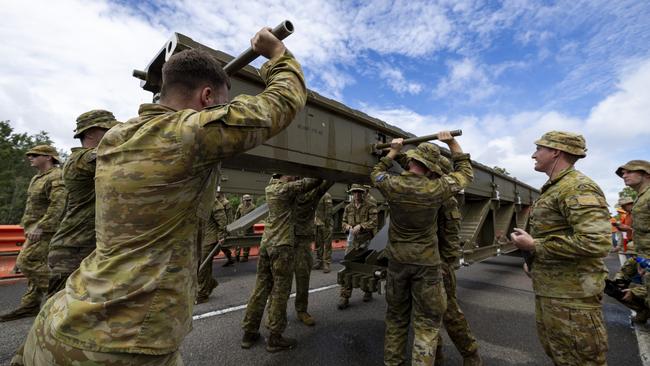 Australian Army soldiers from the 3rd Combat Engineer Regiment assemble a Medium Girder Bridge at Ollera Creek, Townsville, Queensland, during Defence Assistance to the Civil Community (DACC) following severe weather and flooding across the region. PHOTO: CPL Riley Blennerhassett