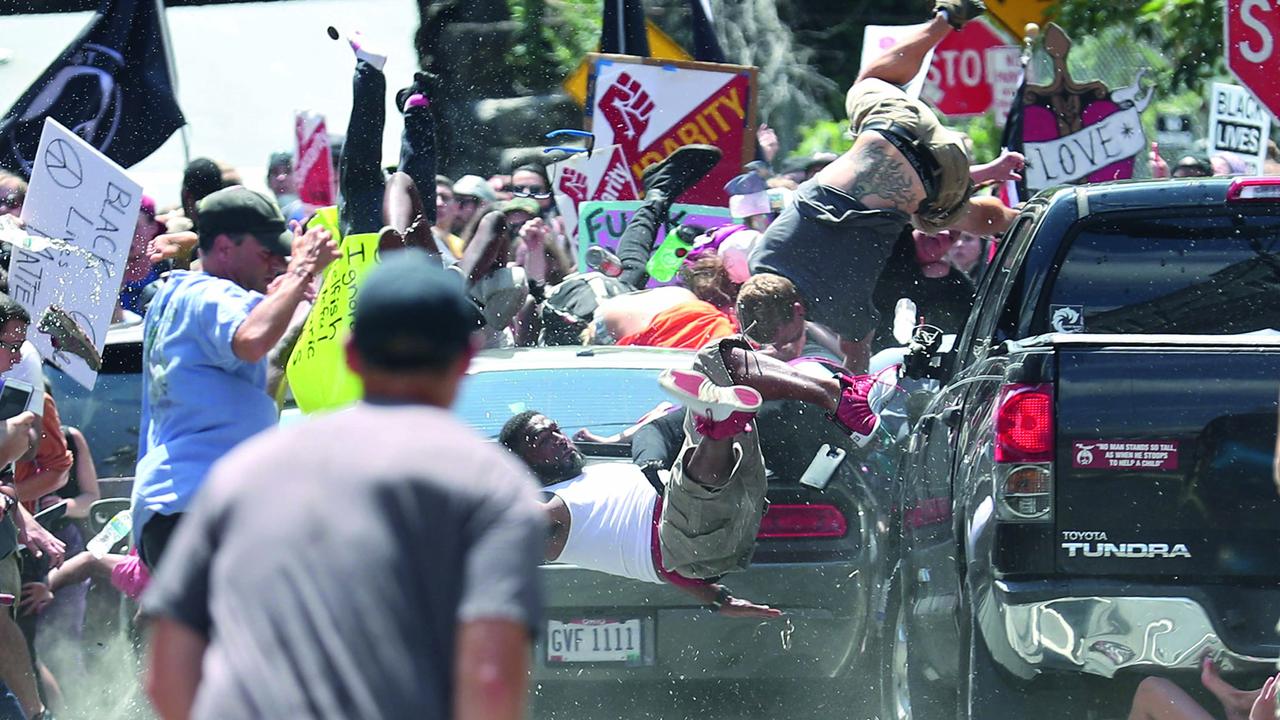 People are thrown into the air as a car ploughs into a group of protesters demonstrating against the Unite the Right rally in Charlottesville in Virginia, USA. Picture: Ryan Kelly/Spot News