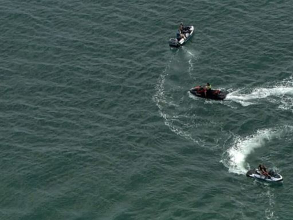 Surf lifesavers monitor the water after a male swimmer disappeared at Port Beach. Credit: 9 News
