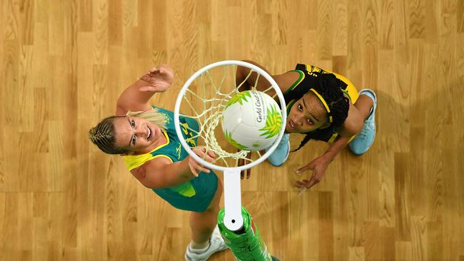 GOLD COAST, AUSTRALIA — APRIL 11: Caitlin Bassett of Australia (L) scores a goal during the Netball Pool A match between Australia and Jamaica on day seven of the Gold Coast 2018 Commonwealth Games at Gold Coast Convention Centre on April 11, 2018 on the Gold Coast, Australia. (Photo by Dan Mullan/Getty Images)