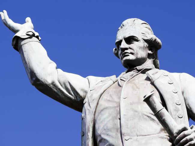 Low angle view of bronze statue Captain James Cook, The explorer, by sculptor Thomas Woolner 1879 in Hyde Park Sydney Australia, against blue sky, full frame horizontal composition with copy space. For: Where, why and when in 2020. Credit: Istock