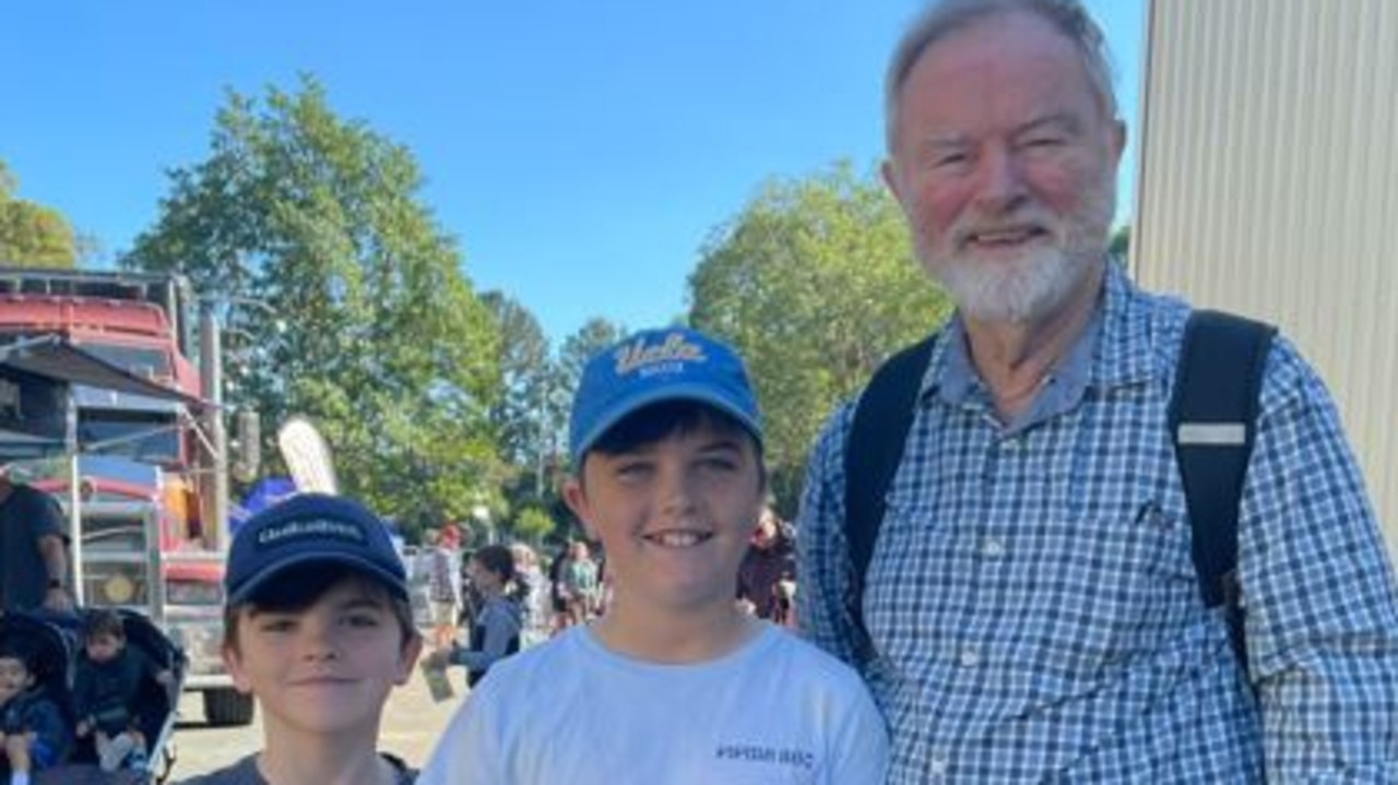 Will Kipping, 9, and Patrick Kipping, 11, with Bill Gilmore at the Sunshine Coast Agricultural Show 2023.