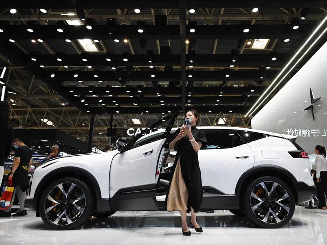 A woman gets out of a Polestar 3 at the Beijing Auto Show in Beijing on May 3, 2024. (Photo by GREG BAKER / AFP)