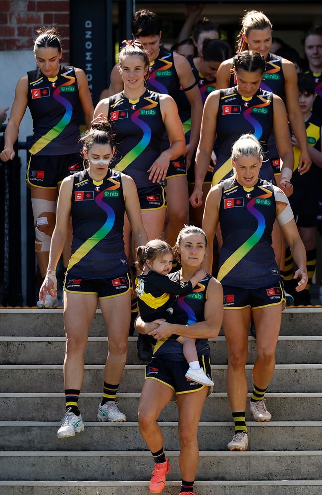 Kate Dempsey and daughter Pippa lead the Tigers out against Geelong. Picture: Michael Willson/AFL Photos via Getty Images.