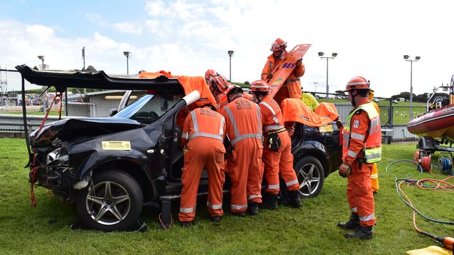 The SES Rescue team take apart a car, explaining to people at the show how they rescue someone who is stuck in a vehicle.