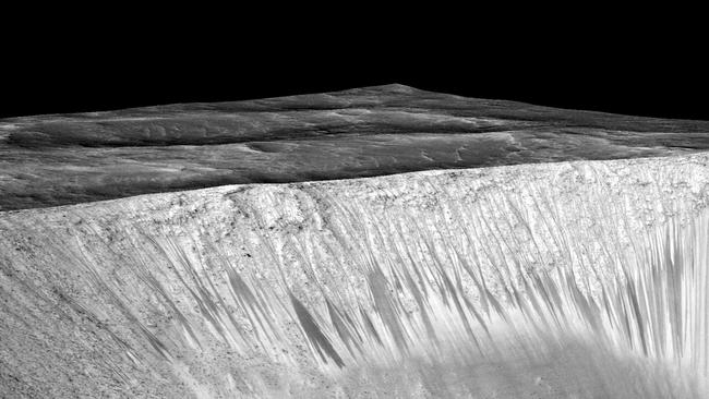 Dark narrow streaks, called “recurring slope lineae”, emanate from the walls of Garni Crater on Mars. The streaks are hypothesised to be formed by flow of briny liquid water.