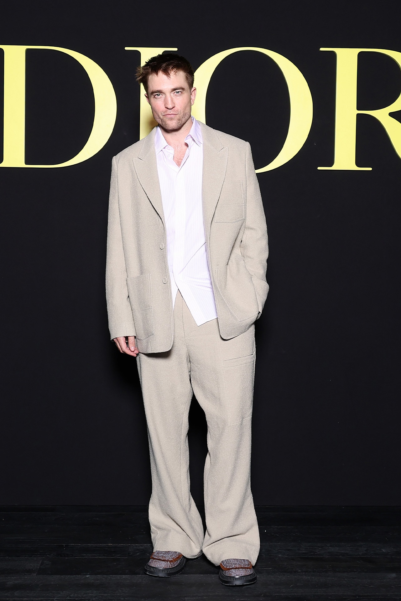 <p><em>Image credits: Getty Images&nbsp;</em></p><p>&nbsp;</p><p>Robert Pattinson, meandering his way to the Dior show in Paris wore an unconstructed suit in beige wool and mohair. Sleeves long, pants absorbing the loafers below, and shirt untucked. A <a href="https://www.gq.com.au/shopping/best-buys/summer-suits-under-1000/image-gallery/d6eab3a67b0b36a2816603289e9b4ebb" rel="noopener" target="_blank">summer-ready</a> appropriation of the enlarged suit if ever we&rsquo;ve seen it.</p><p>&nbsp;</p>