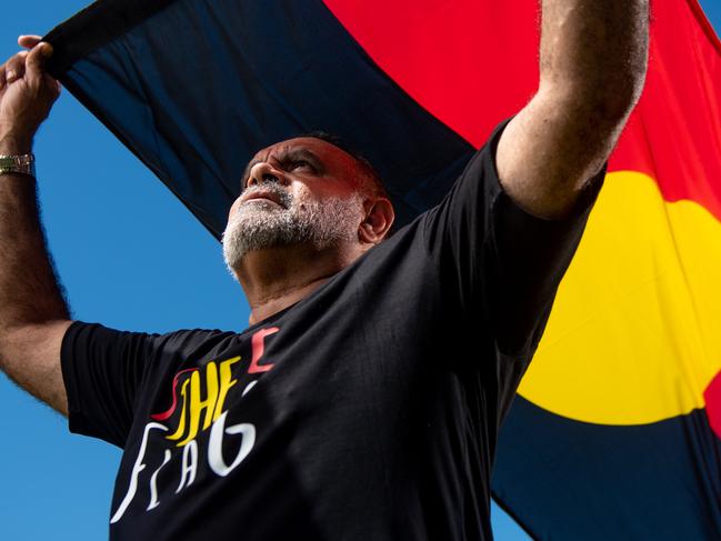 Michael Long stands with the Aboriginal Flag at Gardens Oval, Darwin ahead of the AFL's Dreamtime Round.Picture : Che Chorley