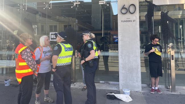 Police are on the scene as protesters chant next to Tour Down Under festivities. Picture: Isabel McMillan