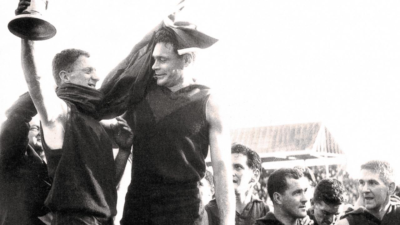 Bluey Adams and Ron Barassi after winning the 1964 grand final.