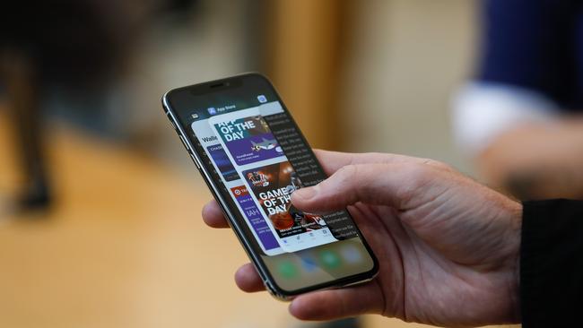 (FILES) In this file photo taken on November 3, 2017 an Apple employee demonstrates the app switcher on the iPhone X at the Apple Store Union Square, in San Francisco, California. - Apple is set to court software savants at its annual developers conference beginning June 3, 2019 while contending with criticism that the iPhone maker has made its App Store a walled garden.The App Store is the lone shop for content for Apple devices, with the technology giant deciding which software creations to accept and taking a 30 percent cut of financial transactions. (Photo by Elijah Nouvelage / AFP)