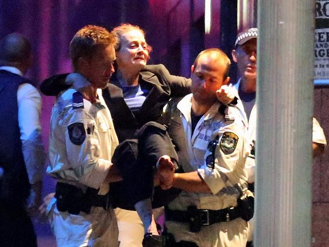 Marcia Mikhael - SYDNEY, AUSTRALIA - DECEMBER 16: A woman carried out by police from the Lindt Cafe, Martin Place following a hostage standoff on December 16, 2014 in Sydney, Australia. Police stormed the Sydney cafe as a gunman had been holding hostages. (Photo by Joosep Martinson/Getty Images)