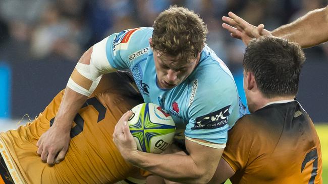 Michael Hooper of the Waratahs is tackled during the Round 15 Super Rugby match between the New South Wales Waratahs and the Jaguares at Bankwest Stadium in Sydney, Saturday, May 25, 2019. (AAP Image/Craig Golding) NO ARCHIVING, EDITORIAL USE ONLY