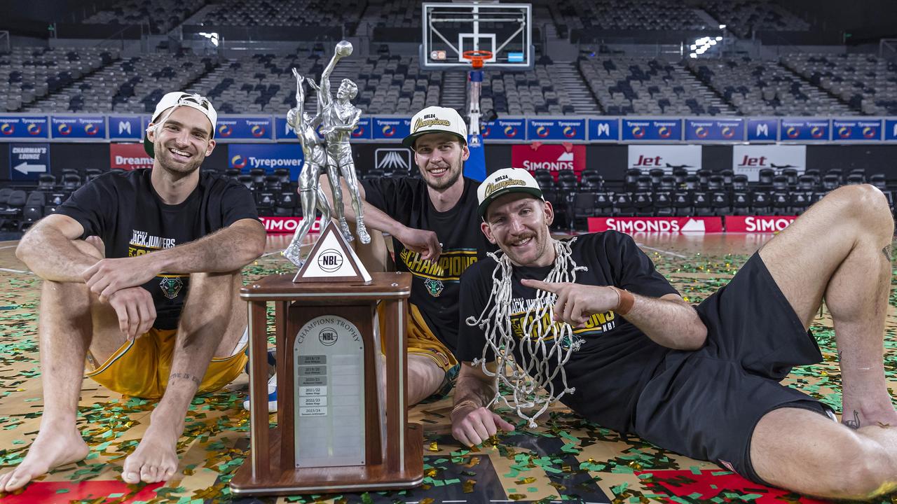 MELBOURNE, AUSTRALIA - MARCH 31: Jack McVeigh, Clint Steindl and Will Magnay of the JackJumpers celebrate with the trophy after winning game five of the NBL Championship Grand Final Series between Melbourne United and Tasmania JackJumpers at John Cain Arena, on March 31, 2024, in Melbourne, Australia. (Photo by Daniel Pockett/Getty Images)