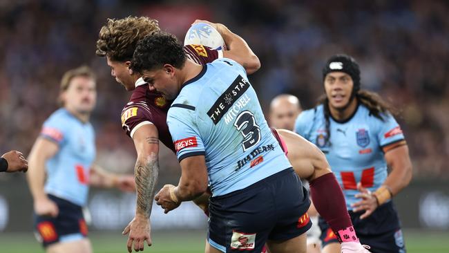 Latrell Mitchell puts Reece Walsh down hard. Picture: Cameron Spencer/Getty Images