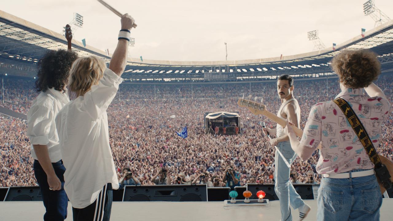 Gwilym Lee (as guitarist Brian May), Ben Hardy (as drummer Roger Taylor), Rami Malek (as frontman Freddie Mercury) and Joe Mazzello (as bassist John Deacon) on stage at the Live Aid concert in a scene from Bohemian Rhapsody. Picture: Twentieth Century Fox