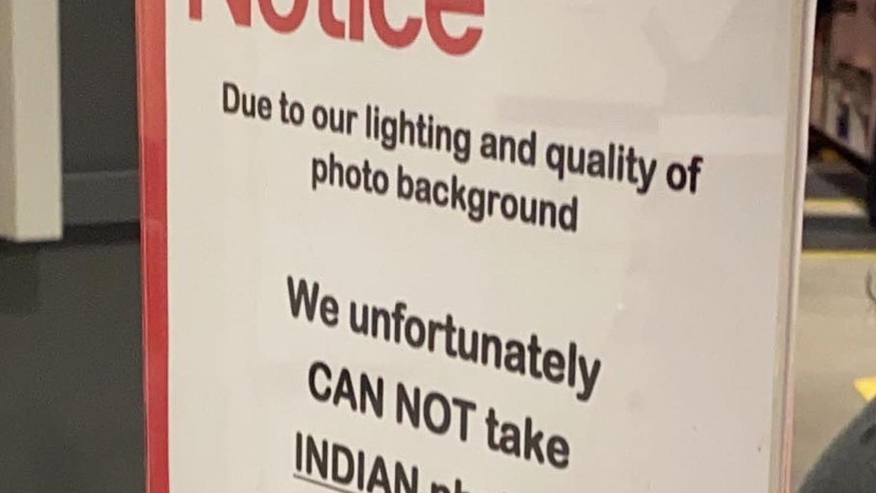 A sign at the City Cross Australia Post indicating they cant do passport photos for Indian people. Picture: @justadelaidethings