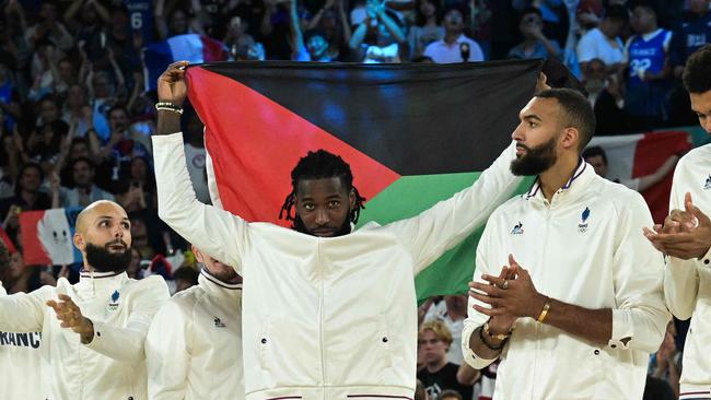 Lessort holds the flag proudly. Photo by Damien MEYER / AFP)