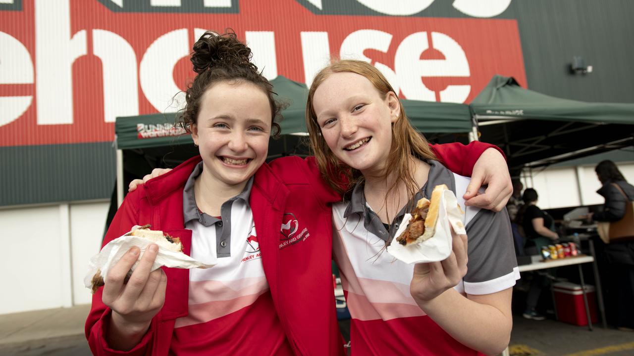 Henley Grange Swimming Club members Delilah McMahon and Lucinda Lugg enjoy a Bunnings Mile End sausage sizzle in 2022. Picture: Naomi Jellicoe