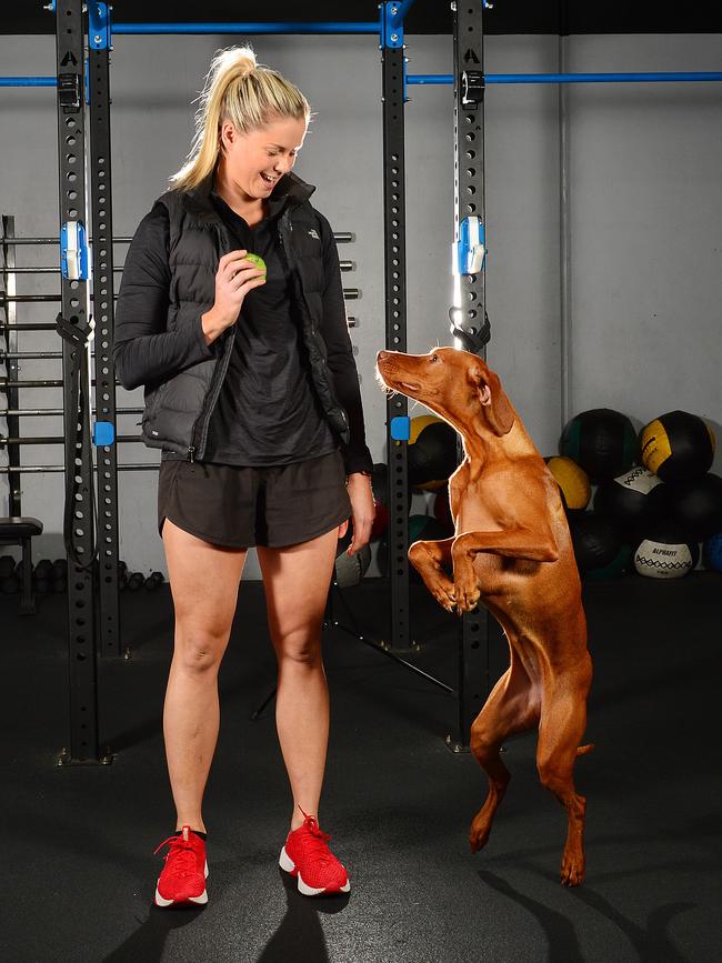 Brennan plays with her dog, Harper in the gym. Picture: Nicki Connolly