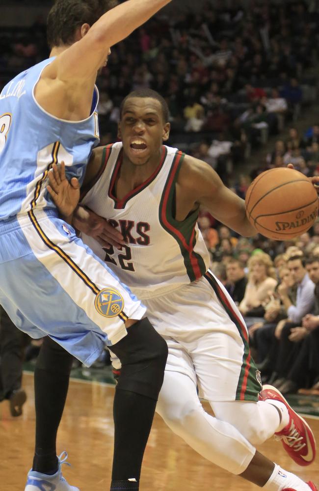 Milwaukee Bucks guard Khris Middleton tries to drive to the basket against Denver Nuggets forward Danilo Gallinari.